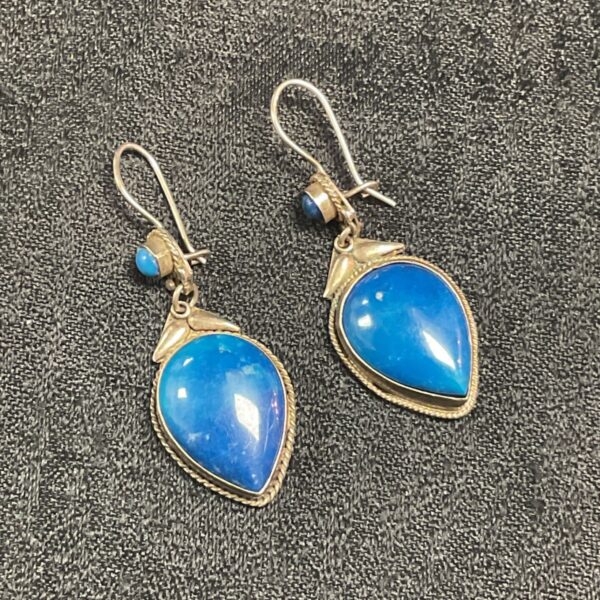 Silver drop earrings with blue chalcedony teardrop stones.