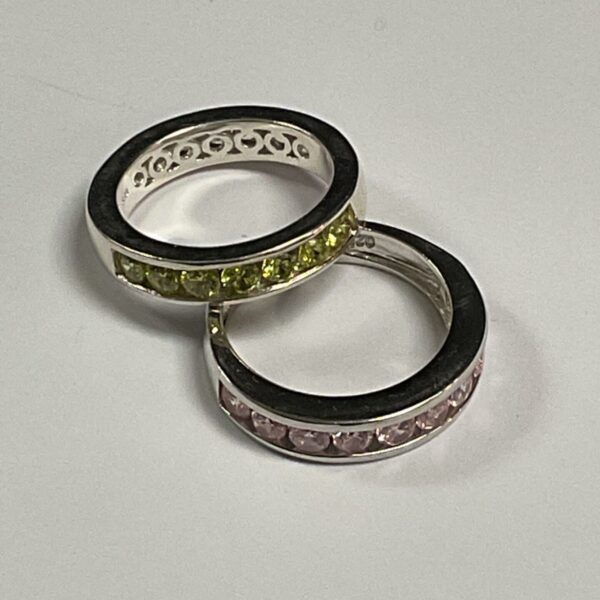 Silver ring set with yellow and pink gemstones.