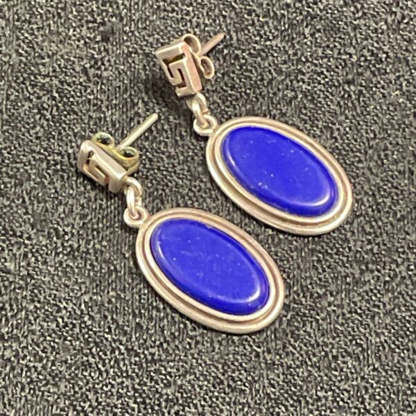 Silver drop earrings with oval lapis lazuli stones.