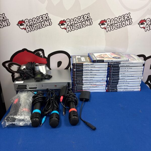 Silver PlayStation 2 console with SingStar games and accessories.