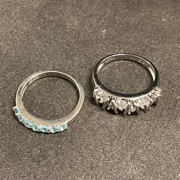 Silver rings with blue and clear stones, sizes M and N.