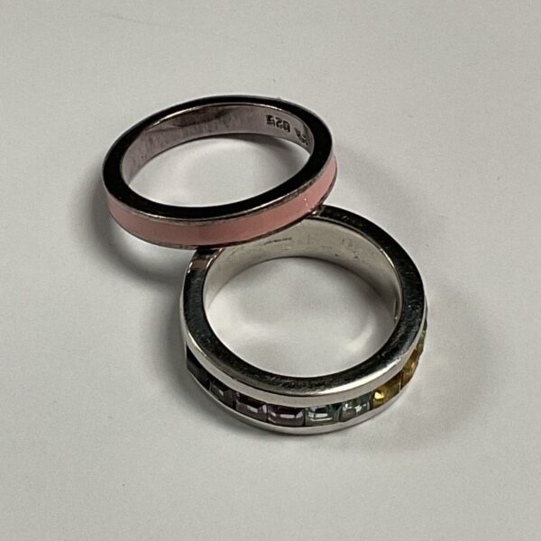 Close-up of a pink enamel silver ring.