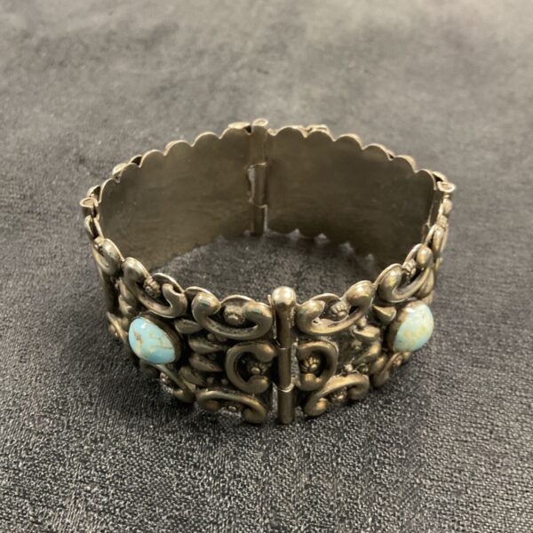 Silver bracelet with turquoise stones, detailed Indian design.