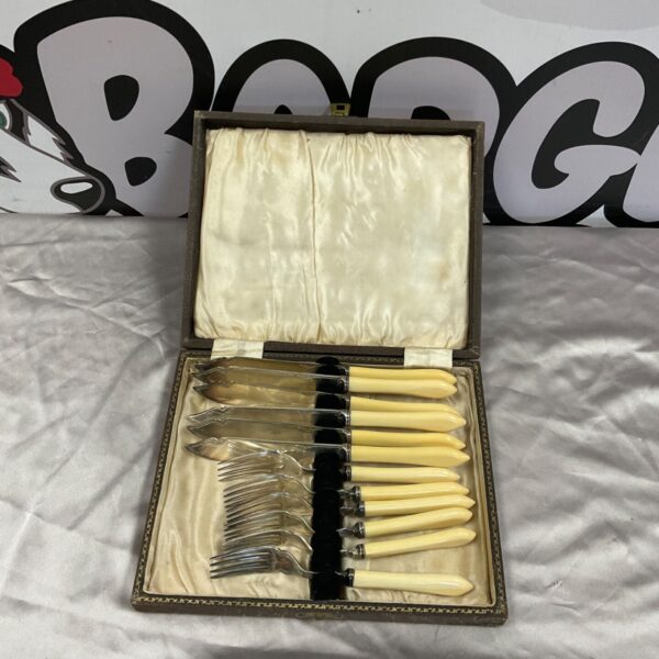 Silverplate fish knives and forks with cream handles in open presentation case