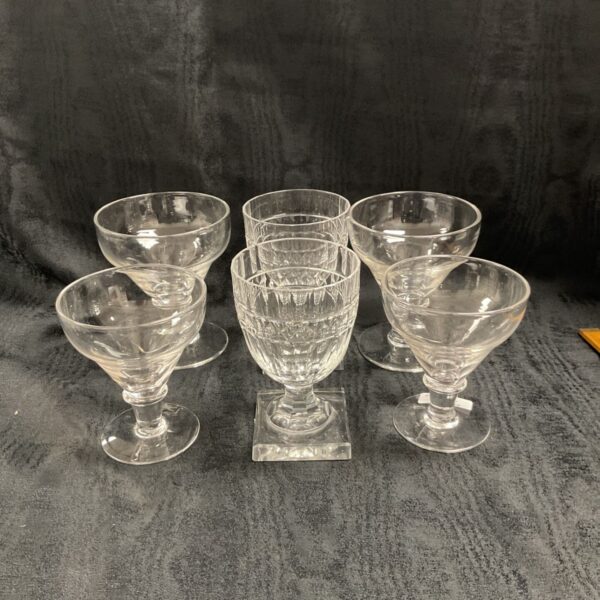 Six hand blown glasses, four plain stemmed bowls and two cut glass tumblers