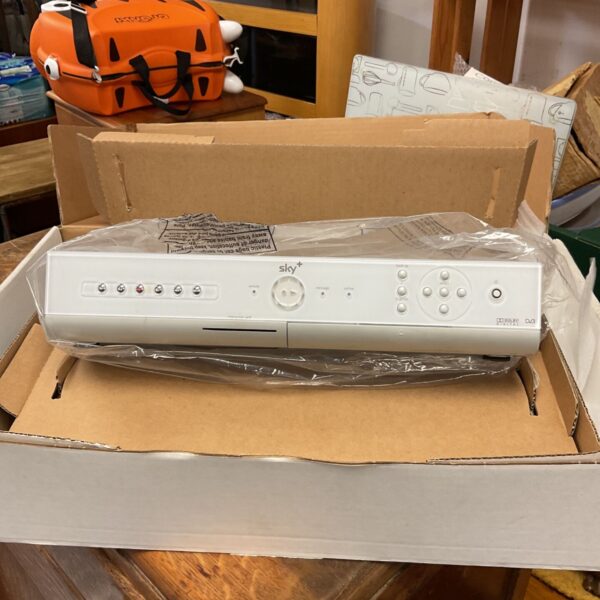 Silver Sky+ TV set-top box in cardboard packaging wrapped in plastic