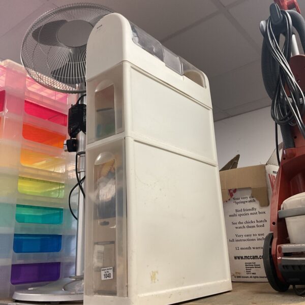 Slim white plastic floor cabinet with rounded top and clear compartments
