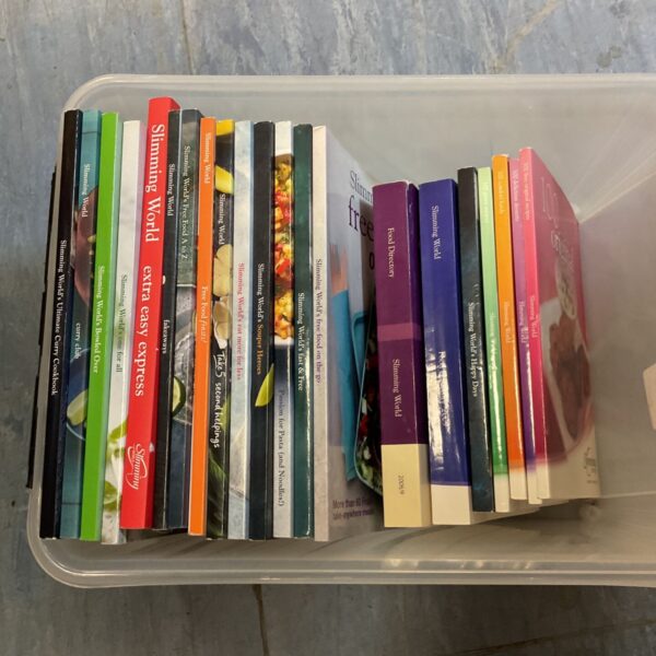 Collection of assorted Slimming World recipe books stored upright in a plastic tub