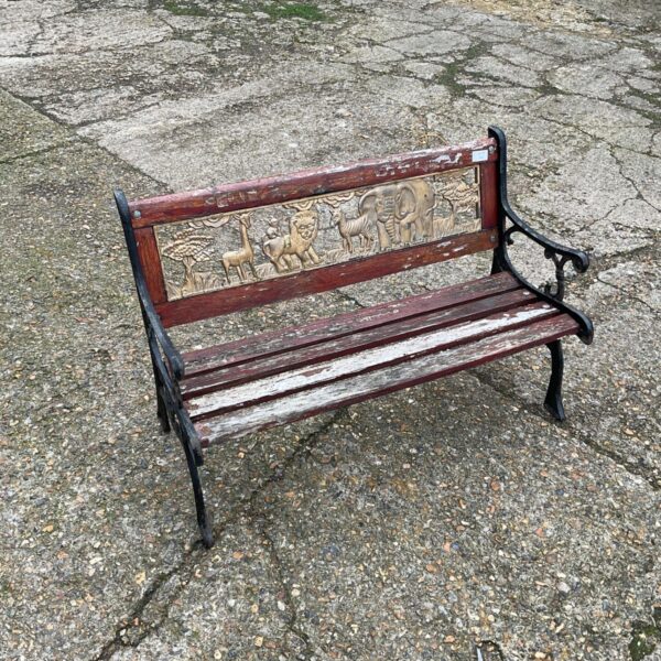 Small child's garden bench with cast iron ends and animal-embossed backrest panel