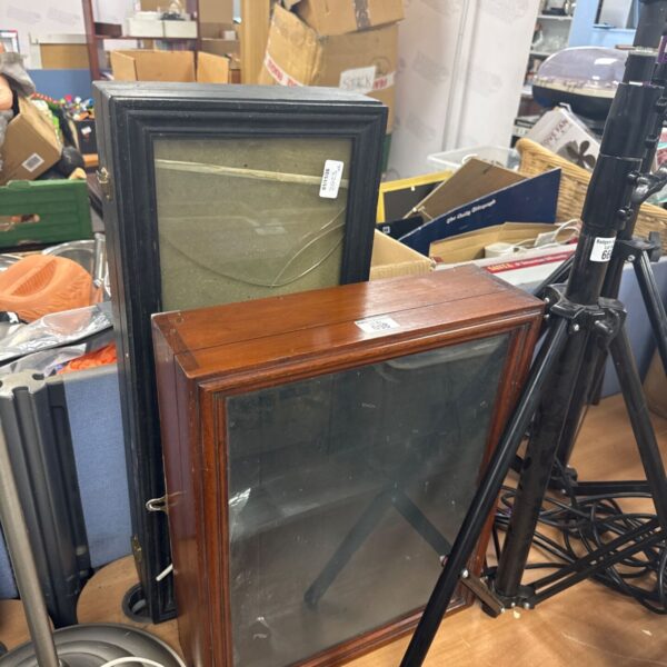 Two small glazed wooden display cabinets, one black and one mahogany-coloured