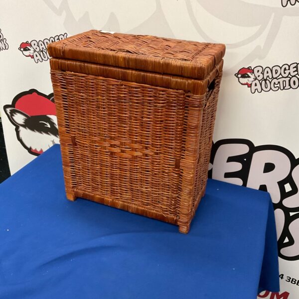 Vintage wicker storage box with a hinged lid, ideal for small items.