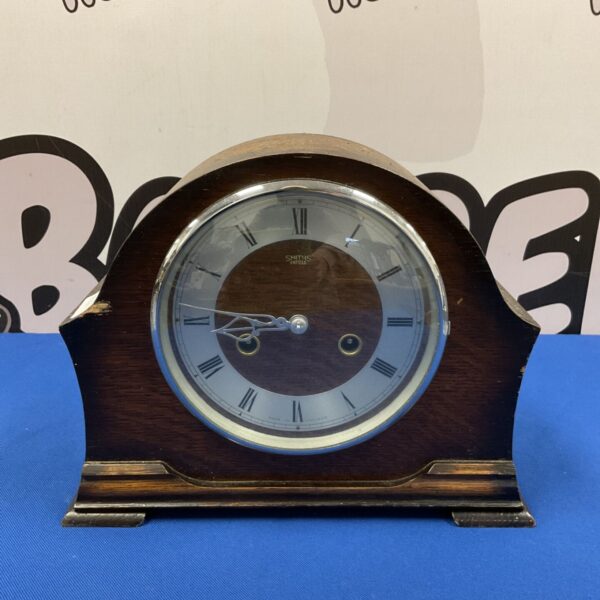 Vintage Smiths Enfield mantle clock with a dark wooden case.