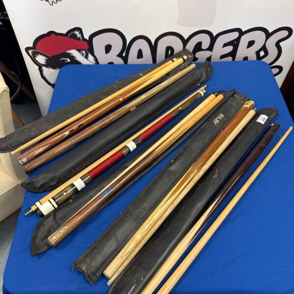 Selection of snooker cues with black cases, including Riley and Pot Black examples