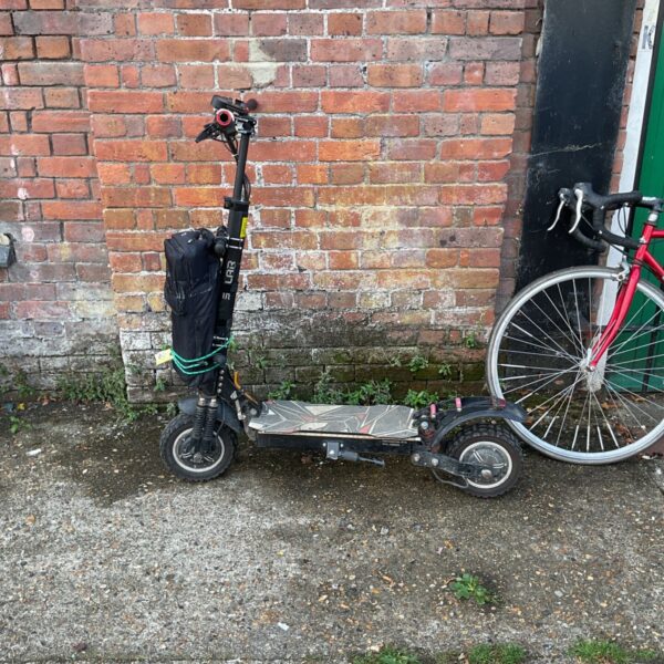 Dark coloured Solar P1 Pro electric scooter, folded for storage.