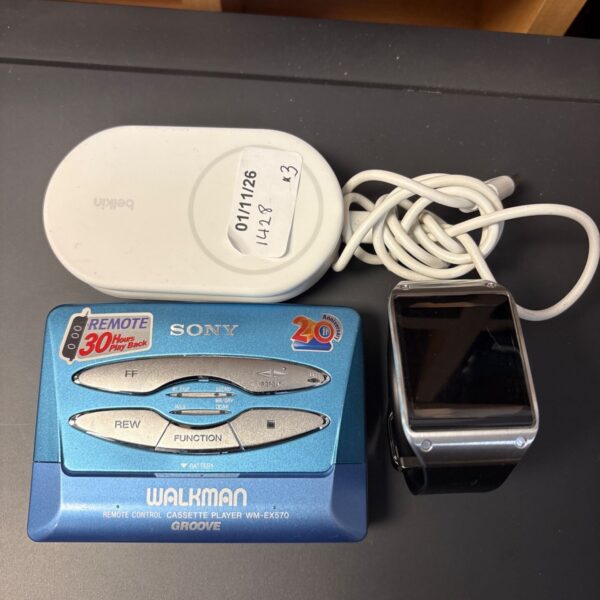 Sony Walkman WM-EX570 cassette player with Samsung smart watch and Belkin charger