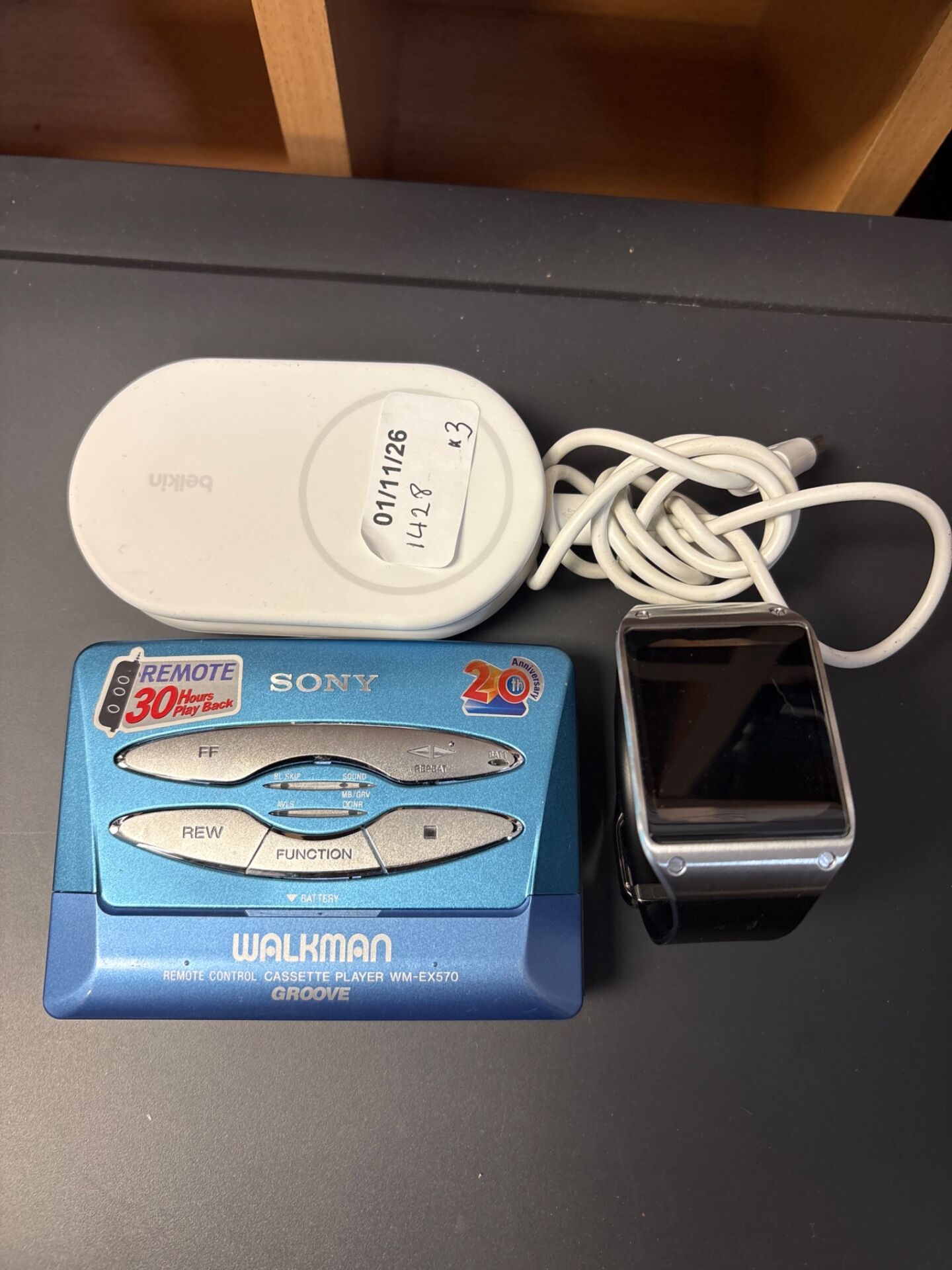 203 Sony Walkman cassette player WM-EX570 with Samsung smart watch and belkin magnetic foldable charger