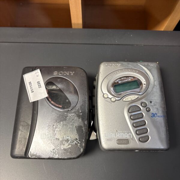 Two Sony Walkman portable players, WM-FX271 and WM-LX120, on a dark surface