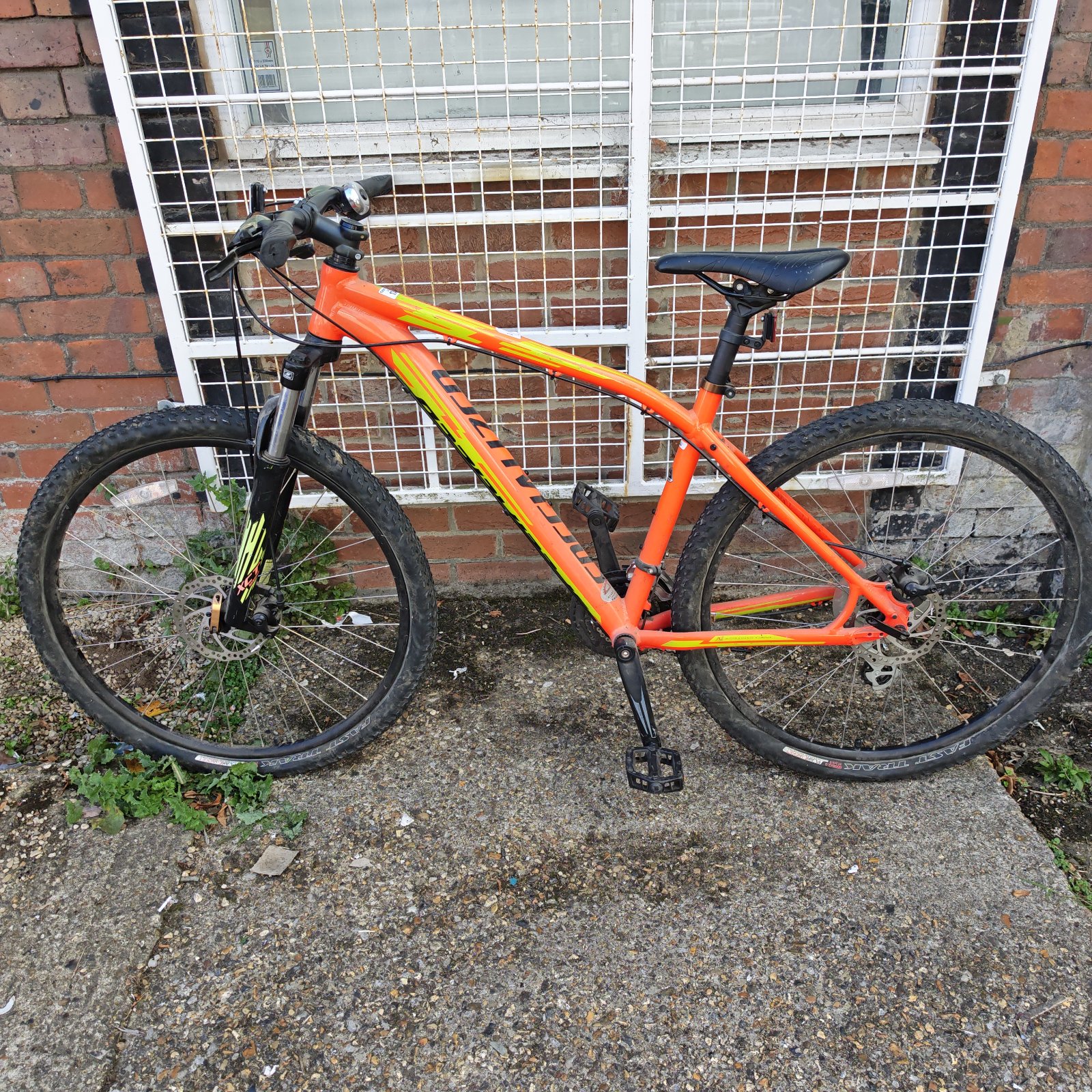 Orange Specialized Pitch mountain bike with front suspension.