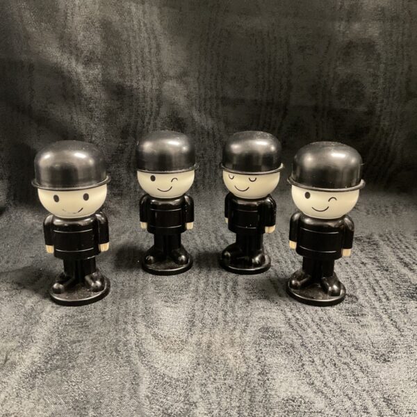 Four vintage Spillers Small Fred flour graders with black hats and smiling faces