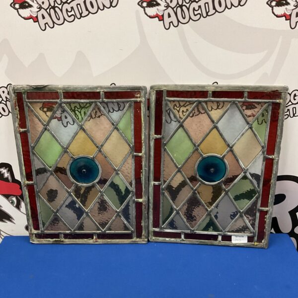 Vintage stained glass windows with geometric design and blue accents.