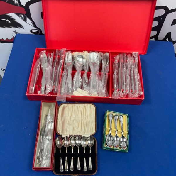 Red cutlery canteen with stainless steel knives, forks and spoons, plus boxed teaspoons