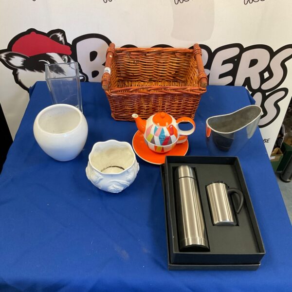 Stainless steel flask and mug set in a woven picnic basket.