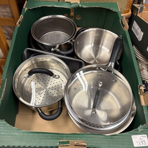 Stainless steel pots and pans set, used kitchen cookware.
