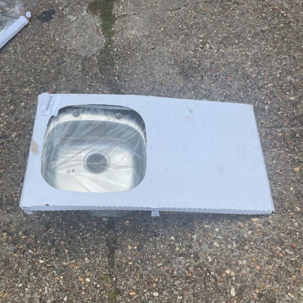 Stainless steel kitchen sink in original packaging, ready for installation.