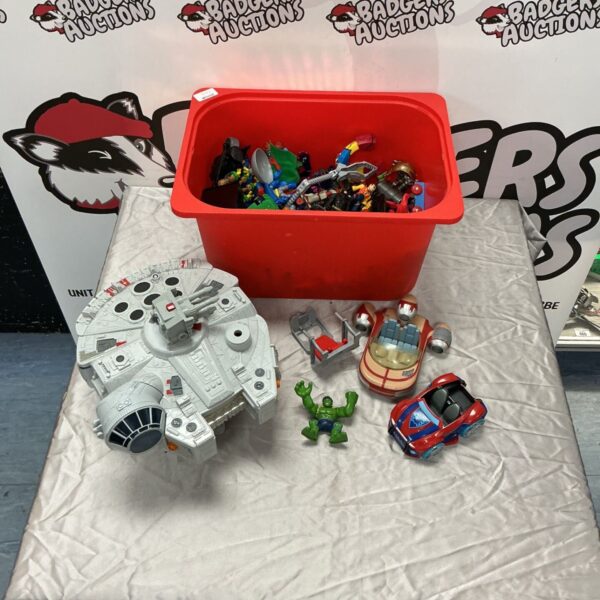 Star Wars Millennium Falcon toy beside Marvel figures and toy vehicles on a table