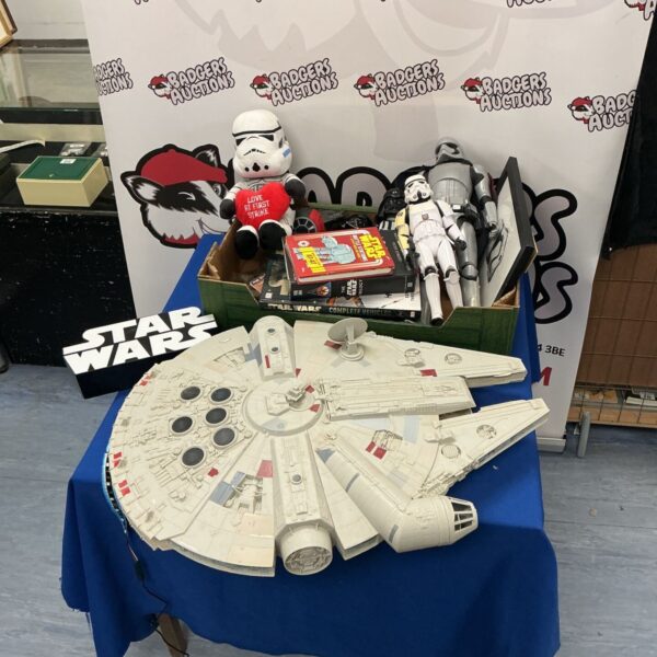 Star Wars toy lot featuring Millennium Falcon and Stormtrooper figures.