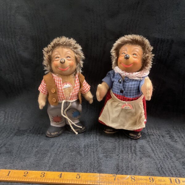 Pair of vintage Steiff Mecki and Micki hedgehog figures in traditional clothing