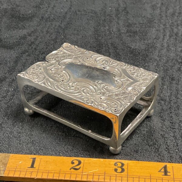 Intricate sterling silver matchbox case with embossed floral design.