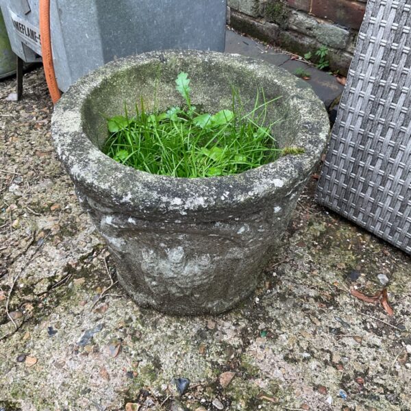 Round stone effect garden planter with moulded band and weathered surface