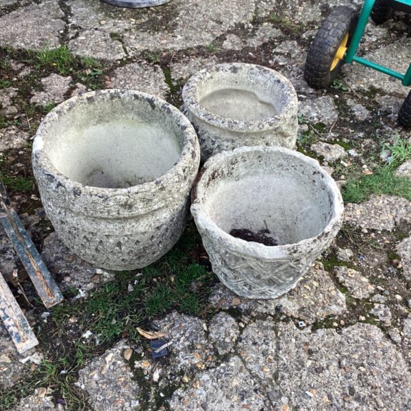 Three weathered stone effect garden planters for outdoor use.