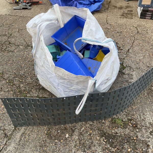 Large bag filled with a lot of plastic storage boxes.
