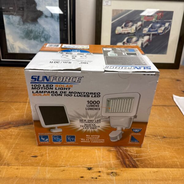 Sunforce solar security light in original box, showing packaging details.