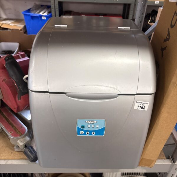 Silver SWS portable countertop ice maker with closed lid and blue control panel
