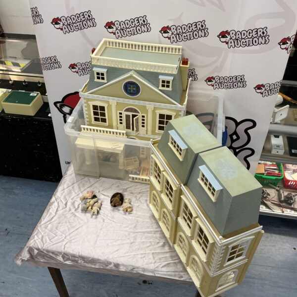 Sylvanian Families doll's house with rooftop balustrade and figures on a table
