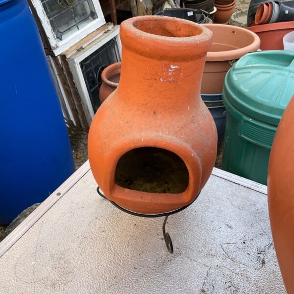 Terracotta table top chiminea for garden or home decor.
