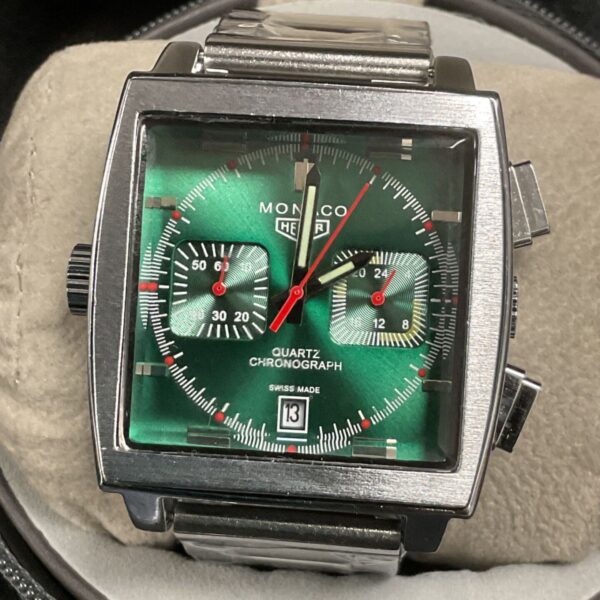 Tag Heuer Monaco reproduction watch with a green dial and silver bracelet.