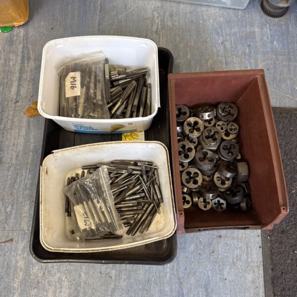 Selection of metric taps and dies in plastic tubs and a brown bin