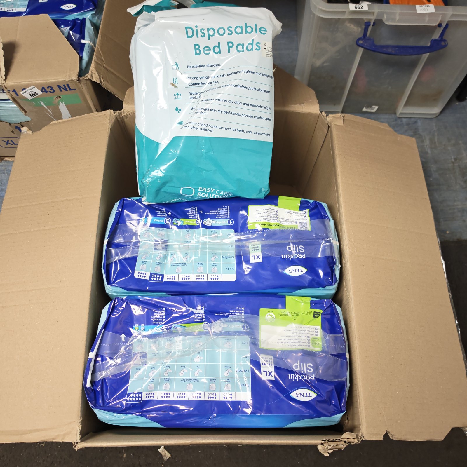 Tena ProSkin Slip XL pads and disposable bed pads boxed in cardboard carton