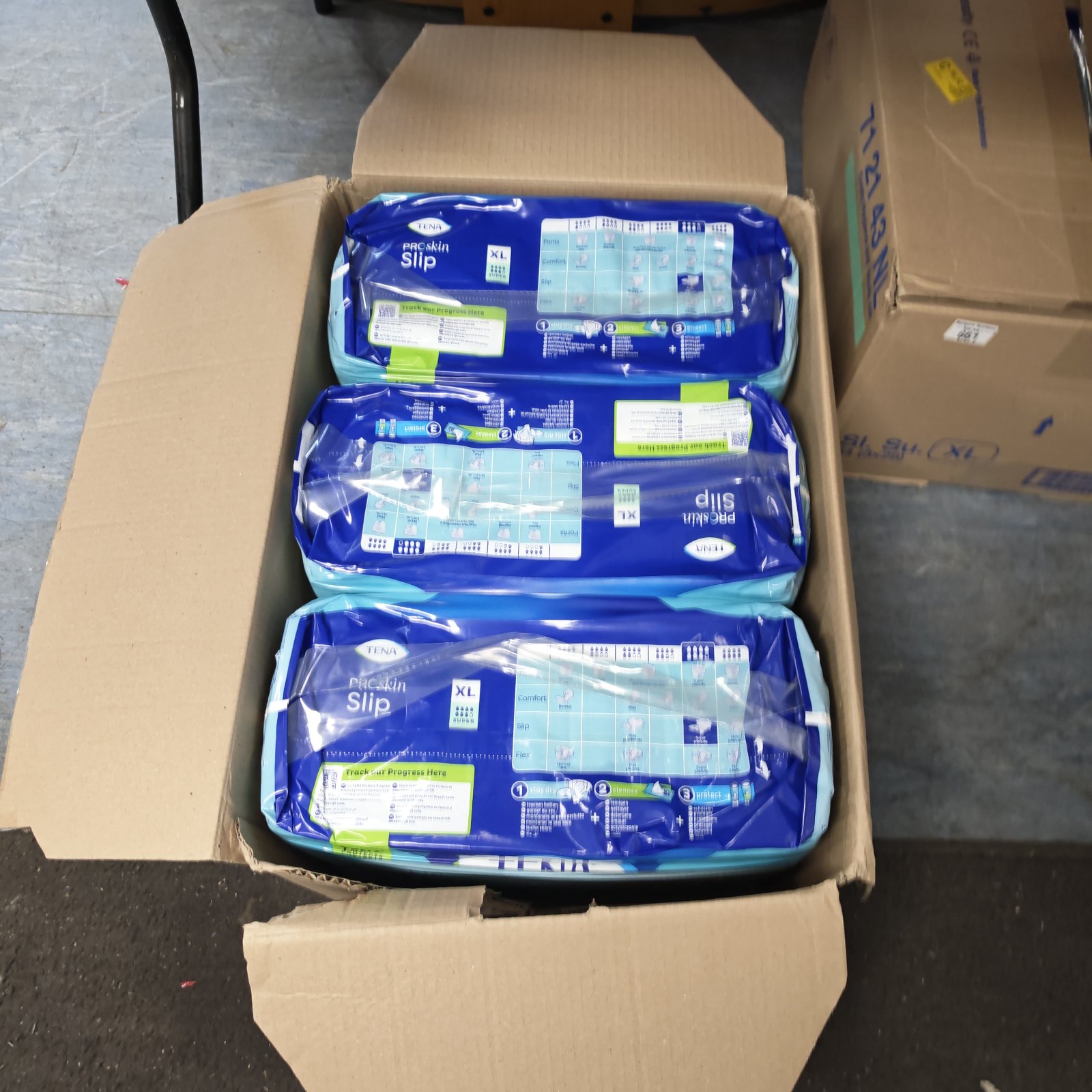 Three sealed packs of TENA ProSkin Slip XL Super in a cardboard carton