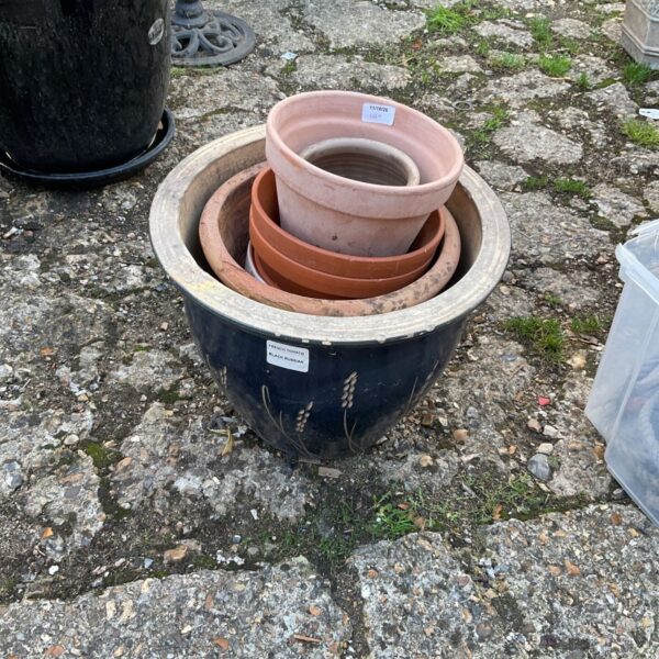 Stacked terracotta garden planters showing varying sizes and rustic patina.