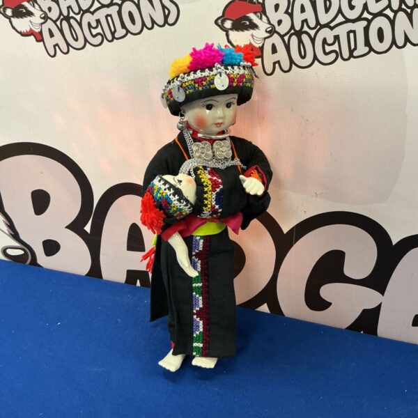Traditional Thai Hilltribe porcelain doll in vibrant costume.
