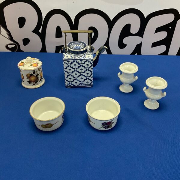 Thai teapot and Royal Worcester dishes, a collectible ceramic set.