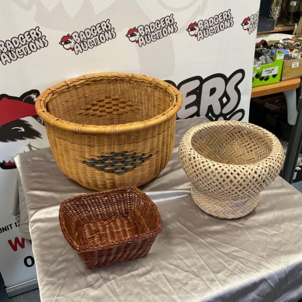 Three wicker baskets in round, rectangular and woven styles on a table