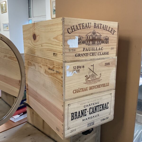 Three stacked wooden wine crates from Chateau Batailley, Chateau Beychevelle and Chateau Brane-Cantenac