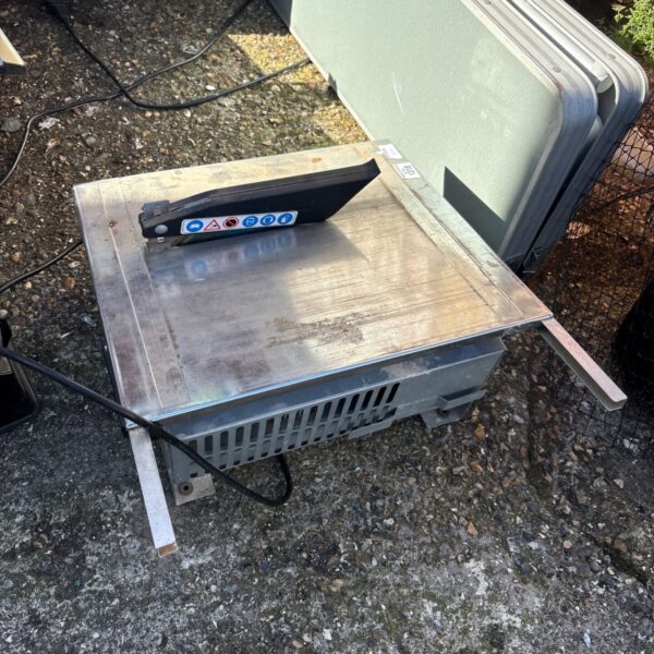 Front view of a used tile cutting saw.