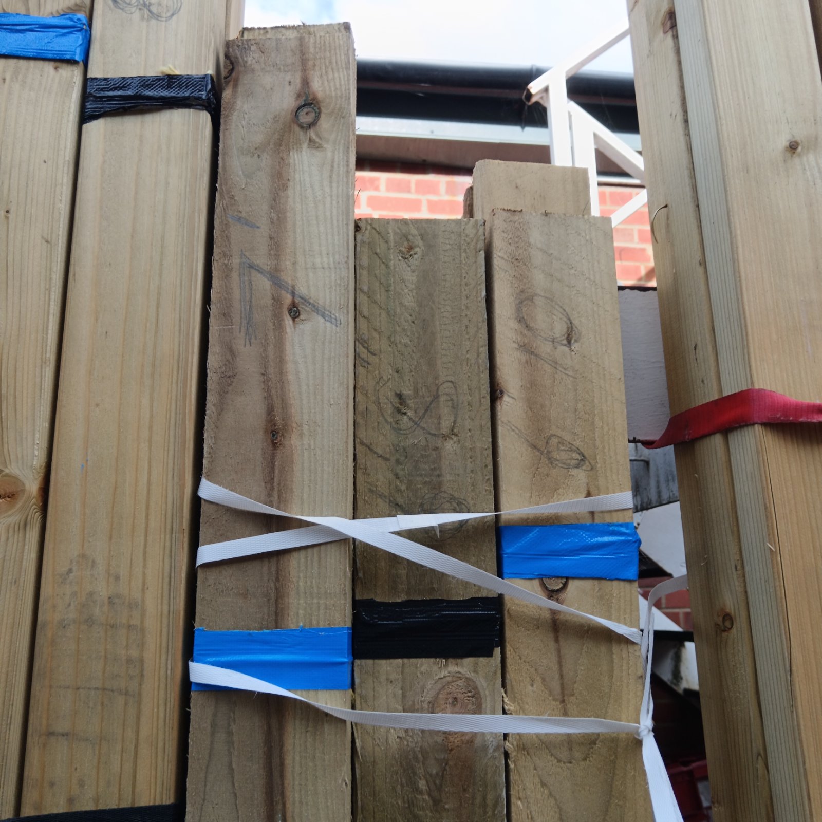 Strapped bundles of 6ft to 7ft timber for construction projects.